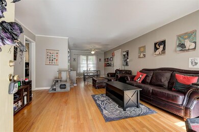 Living room featuring ceiling fan, light hardwood 