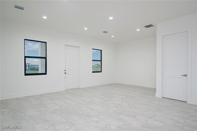 Empty room featuring light tile patterned floors