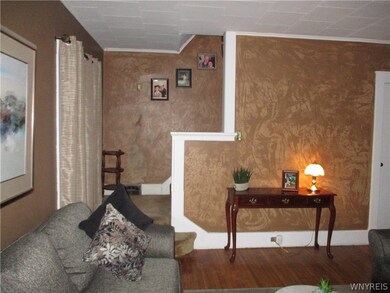 Warm and inviting living room with beautiful hardwood floors & custom paint.