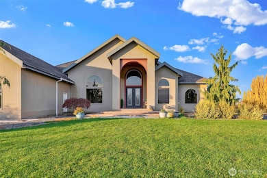 Grand entrance featuring marble tile and custom chandelier