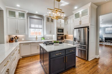 Kitchen with light stone countertops, white cabine