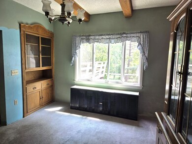 Unfurnished dining area featuring a chandelier, ca