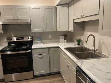 Kitchen with stainless steel appliances, a sink, t