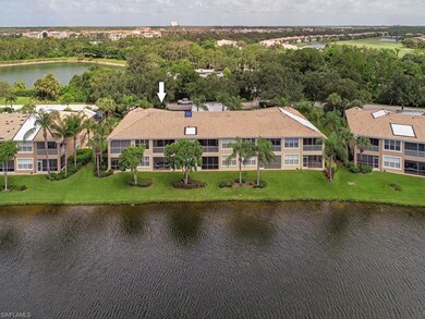 END condo is extreme left in photo: Take in a beautiful landscaped & full lake view from ENCLOSED and TILED lanai that is bright southeast facing!