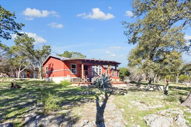 Rear view of property with a lawn and a deck