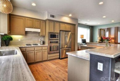 Open kitchen with marble counters and back splash