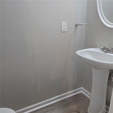 Bathroom featuring baseboards and wood finished floors
