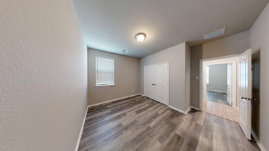 ANOTHER SECONDARY BEDROOM, NOTICE THE VINYL PLANK FLOORING.