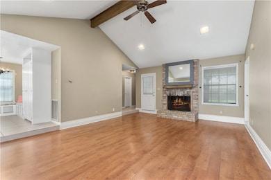 Unfurnished living room featuring a ceiling fan, l