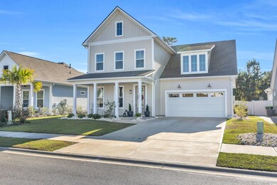 View of front of property with a front lawn, a gar
