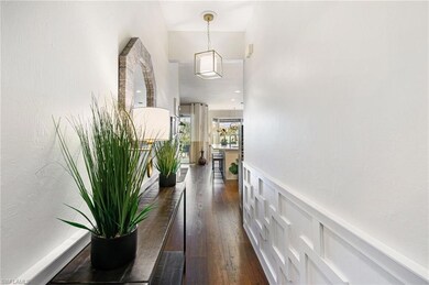 Doorway to outside with a decorative wall, dark wo