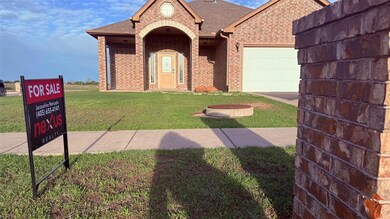 View of front of house with brick siding, a garage
