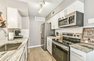 Deep stainless sink and beautiful white cabinetry