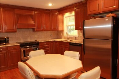 The gourmet kitchen w/beautiful wood cabinetry, st