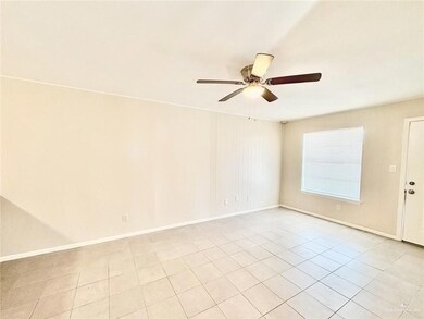 Unfurnished room featuring a ceiling fan and light tile patterned flooring