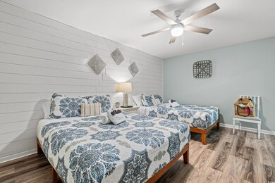 Bedroom with ceiling fan, hardwood / wood-style fl