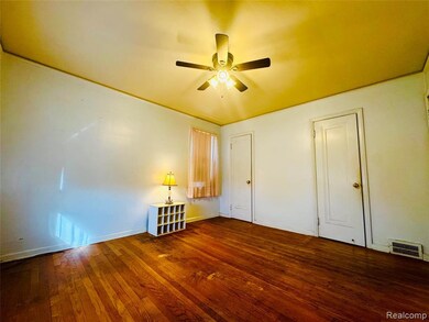 Unfurnished bedroom with dark wood finished floors and ceiling fan