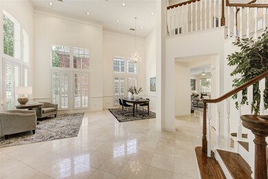 Soaring two story ceilings and floor to ceiling wi