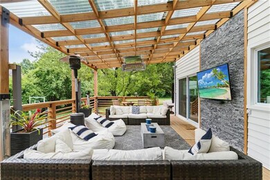 Amazing huge deck with retractable privacy panels, stone accent, radiant heat and sliding doors into kitchen area.Has gas line for fire pit too.