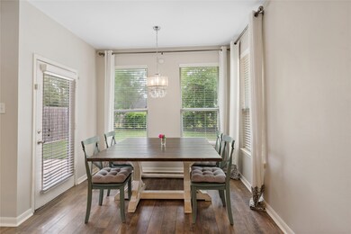 Breakfast area has updated lighting, nice view of your backyard.