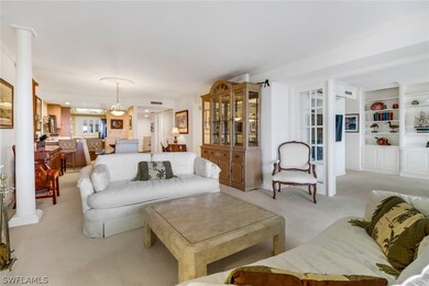 Living room with built in features, light carpet,