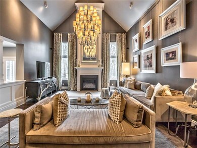 The impressive family room with a dramatic vaulted ceiling, large bespoke mirror and full length curtains that stay with the home.