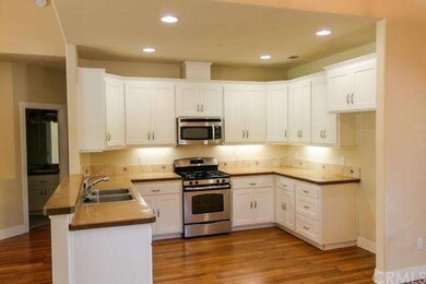Elegant kitchen with laminate bamboo flooring, sta