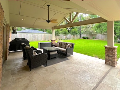 View of patio with outdoor lounge area, grilling a
