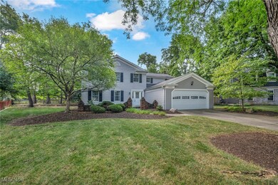 View of front facade featuring a garage and a front lawn