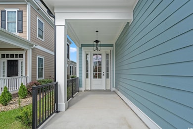 Doorway to property featuring covered porch