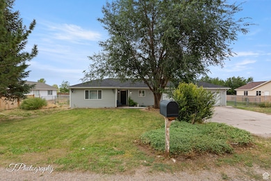 View of front of property featuring concrete driveway
