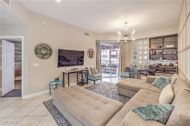 Living area featuring a chandelier, light tile pat