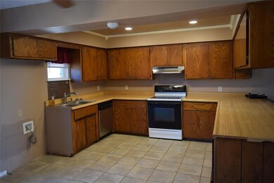 Kitchen with dishwasher, white electric range oven