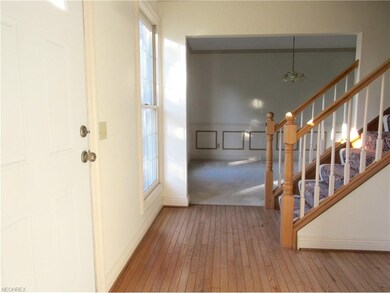 New front door welcomes you into the wood floor fo