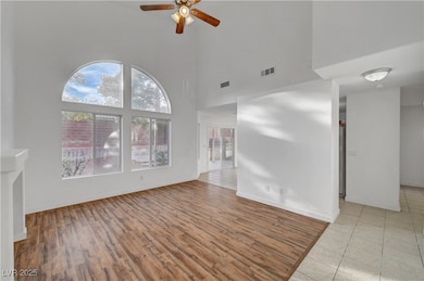 Empty room with a ceiling fan, visible vents, base