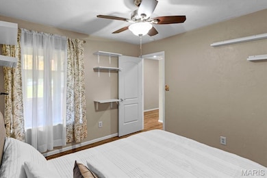 Bedroom featuring wood finished floors and a ceiling fan