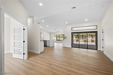 Unfurnished living room with sink and light wood-t