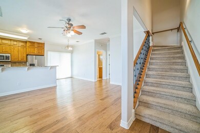 Stairs featuring ceiling fan, wood finished floor