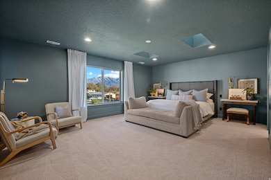 Carpeted bedroom with a textured ceiling, a skylight, recessed lighting, and a mountain view