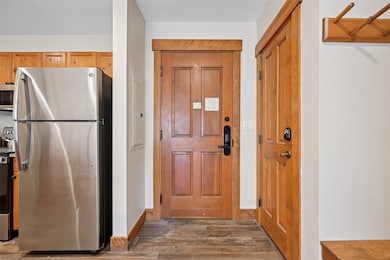 Entryway featuring dark wood-style floors and electric panel