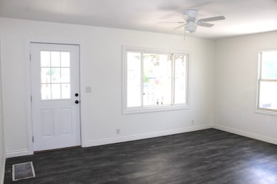 Foyer entrance featuring dark wood-type flooring and a ceiling fan
