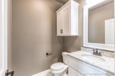 Half bath off of front entry has exotic granite &