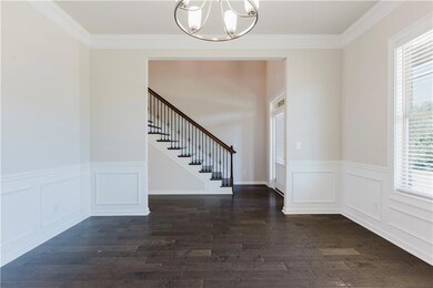 Foyer featuring stairs, ornamental molding, a chan