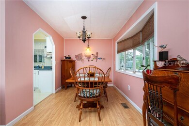Dining room has an attractive light fixture & bay window which keeps this room light & bright.