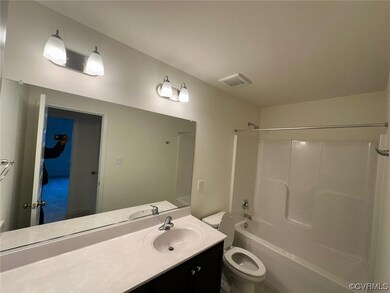 Full bathroom featuring toilet, vanity with extensive cabinet space, and shower / washtub combination