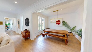 Dining space with a chandelier, ornamental molding, light wood-style flooring, baseboards, and recessed lighting