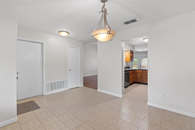 Empty room featuring light tile patterned floors 