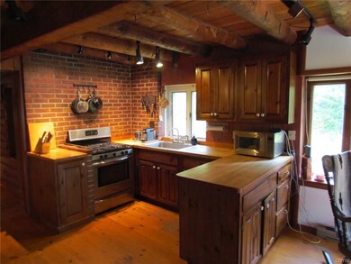 There is a fireplace on opposite wall and a pantry
