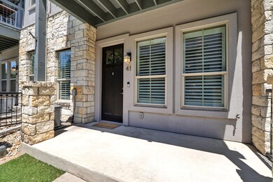 View of exterior entry featuring stone siding, st