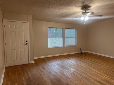 Spare room with wood finished floors, ceiling fan